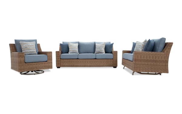 Outdoor patio furniture set featuring a wicker swivel armchair, a three-seat wicker sofa, and a two-seat wicker loveseat with blue cushions and striped accent pillows.