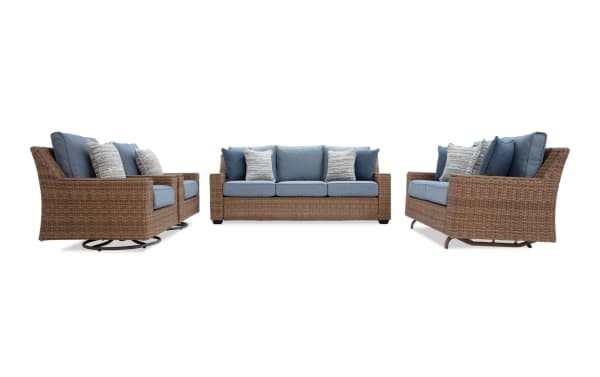 Outdoor patio furniture set with woven rattan frames and blue cushions, including a loveseat, sofa, and armchair with decorative pillows.
