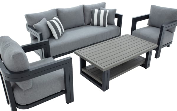 Modern outdoor patio furniture set featuring a gray fabric three-seater sofa, two matching armchairs with black metal frames, and a rectangular slatted coffee table with a lower shelf.