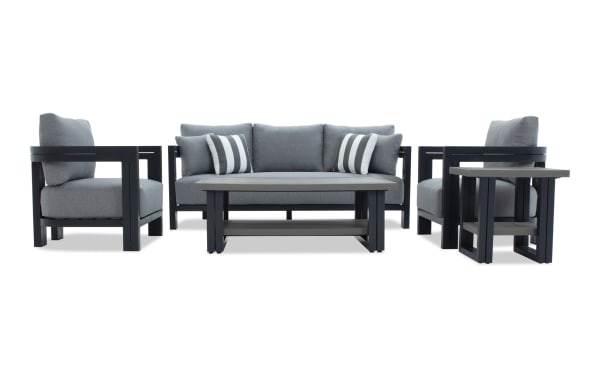 Modern outdoor patio furniture set featuring a gray cushioned sofa and armchairs with black metal frames, plus matching coffee and side tables.