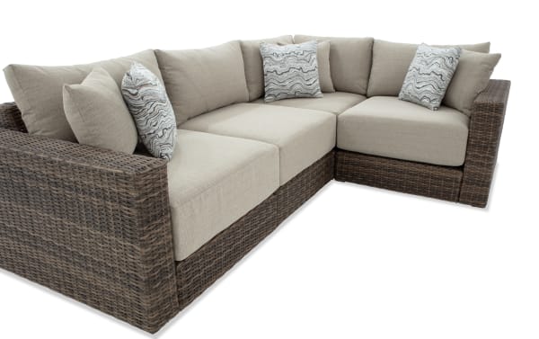 Modular Bob® 4 Piece Beige & Brown Wicker Outdoor Conversation Set with all-weather wicker, rust-proof aluminum frame, beige polyester cushions, and patterned accent pillows in transitional style.
