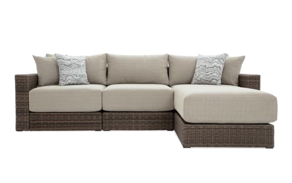 Modular Bob® 4 Piece Beige & Brown Wicker Outdoor Conversation Set with Ottoman, transitional style, all-weather wicker, rust-proof aluminum frame, beige polyester cushions with memory foam, versatile configuration for outdoor spaces.