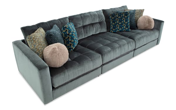 Emerald Jewels 131'' 3-piece modular sofa with plush polyester fabric, gel memory foam cushions, and assorted patterned accent pillows in glam style.
