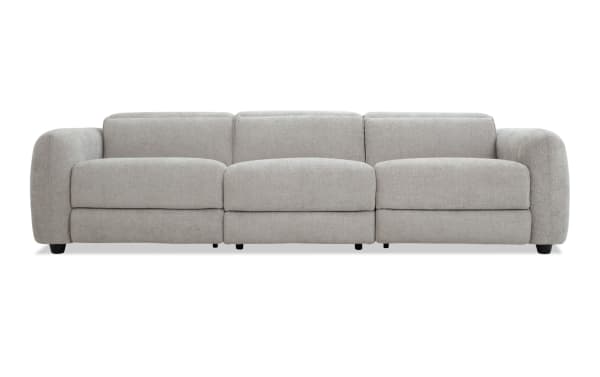 Modern light gray fabric sofa with three cushioned seats, rounded armrests, and low black legs, ideal for contemporary living rooms.