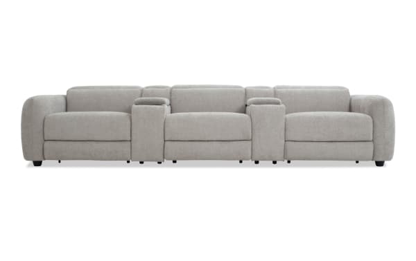 Modern light gray fabric sectional sofa with plush cushions, wide armrests, and built-in center console for storage and cup holders.