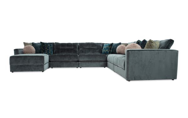 Emerald green Jewels 7-piece modular sectional sofa with plush polyester fabric, Bob-O-Pedic gel memory foam cushions, accent pillows, and hidden storage ottoman in glam style.