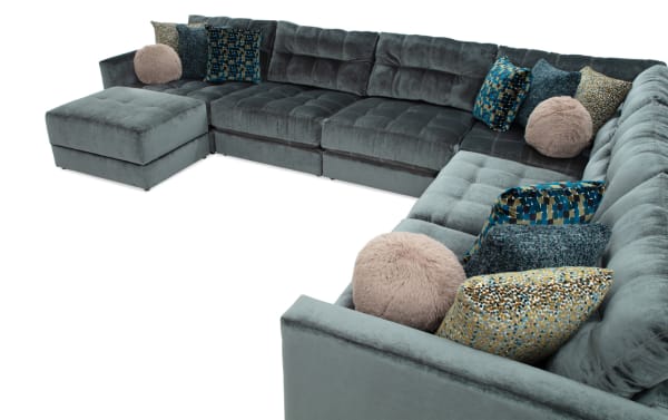 Emerald green Jewels 7-piece modular sectional sofa with plush polyester fabric, gel memory foam cushions, accent pillows, and storage ottoman.