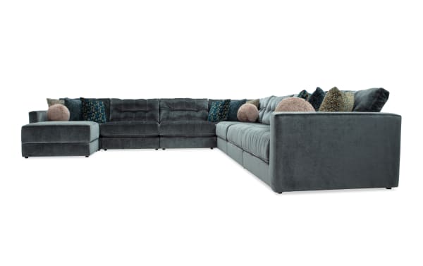 Emerald green Jewels 8-piece modular sectional in glam style, polyester fabric upholstery, includes armless chairs, corner, storage ottoman, and accent pillows.