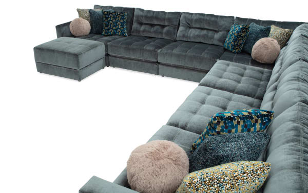 Emerald green Jewels 8-piece modular sectional with plush polyester fabric, tufted cushions, gel memory foam, accent pillows, and storage ottoman.