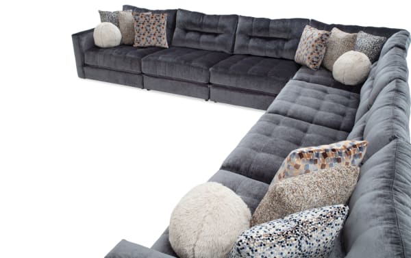 Charcoal gray Jewels 7-piece modular sectional sofa with plush polyester fabric, gel memory foam cushions, and assorted patterned accent pillows.