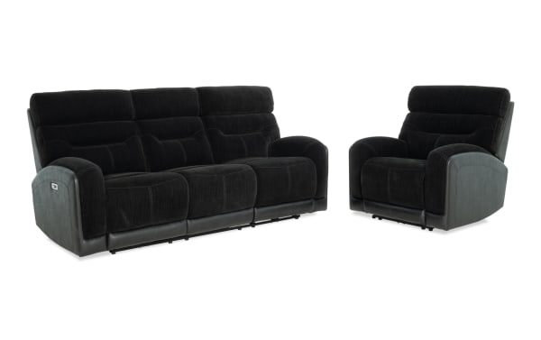 Black fabric and faux leather reclining sofa and armchair set with plush cushioning and padded armrests, ideal for modern living rooms.