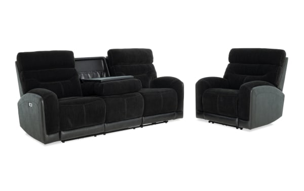 Black fabric and leather reclining sofa set with a three-seat couch featuring a center console and a matching single armchair, designed for living room comfort.