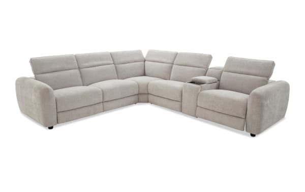 Modern L-shaped sectional sofa in light gray fabric upholstery with plush cushioning, wide armrests, and built-in center console for storage and cup holders.