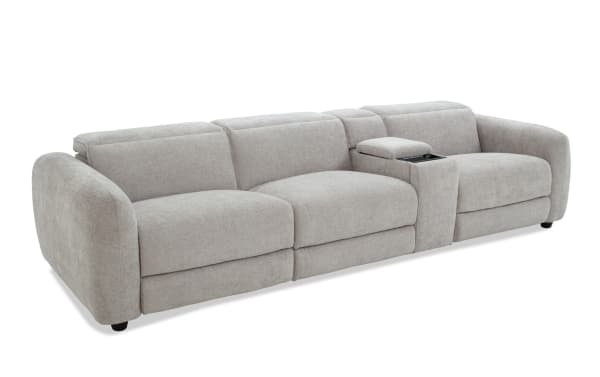 Modern light gray fabric sectional sofa with wide armrests, plush cushions, and a built-in center console with storage and cup holders.
