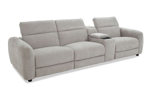 Modern light gray fabric reclining sofa with three seats, adjustable headrests, and a central console with cup holder for living room comfort.