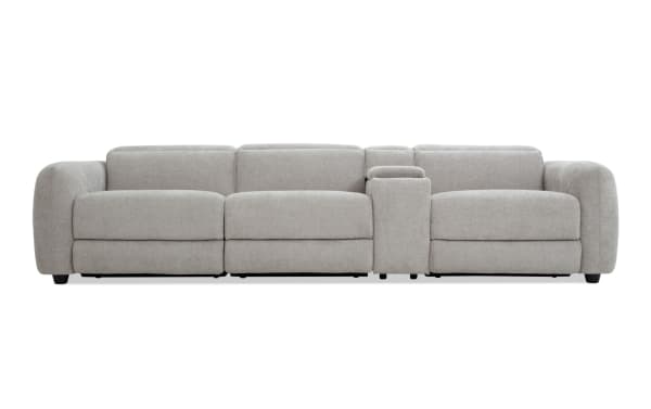 Modern light gray fabric sectional sofa with plush cushions, wide armrests, and a built-in center console for storage and cup holders.