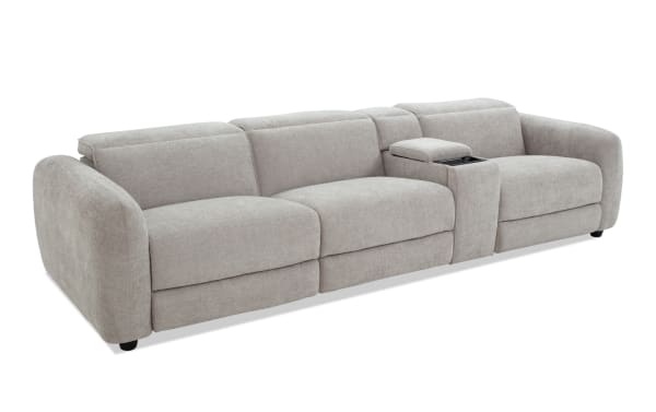 Modern light gray fabric sectional sofa with plush cushions, rounded armrests, and a built-in center console for storage and cup holders, ideal for living room seating.