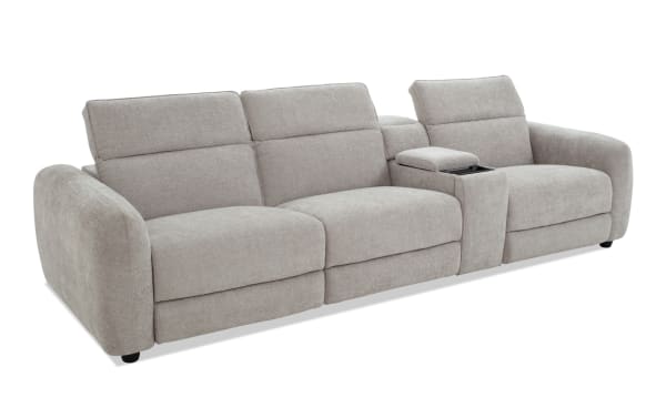 Modern light gray fabric sectional sofa with three cushioned seats, wide armrests, and a built-in center console with storage and cup holder.