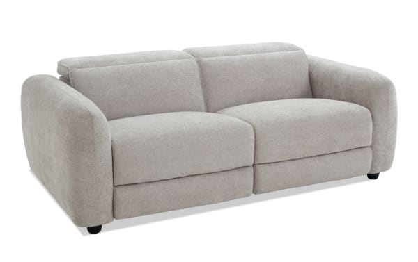 Modern light gray fabric sofa with rounded armrests, plush cushions, and a low backrest, ideal for contemporary living rooms.