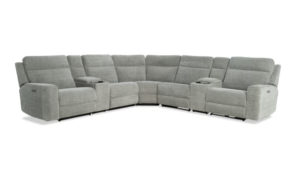 Gray fabric sectional recliner sofa with cup holders, plush cushioned seats, and padded armrests, designed for living room comfort.