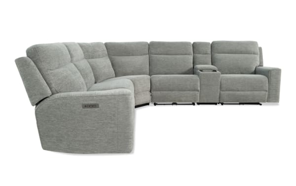 Gray fabric sectional recliner sofa with adjustable headrests, cup holder console, and plush cushioning designed for living room comfort.