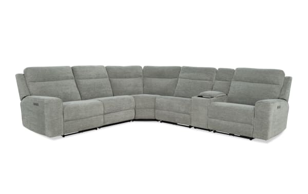 Gray fabric sectional sofa with reclining seats and a built-in console, featuring plush cushioning and modern design for living room comfort.