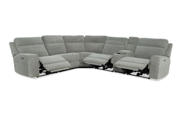 Gray fabric sectional sofa with three reclining seats, plush cushioning, and a built-in center console with cup holders, designed for comfort and modern living rooms.