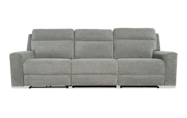 Modern gray fabric reclining sofa with three seats, padded armrests, and cushioned backrests, designed for living room comfort.