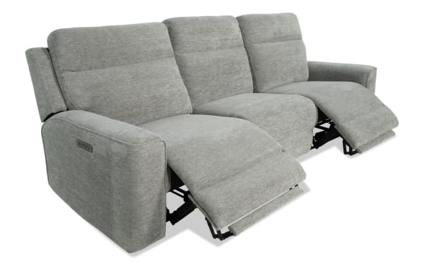Gray fabric three-seat power reclining sofa with padded armrests and adjustable footrests, modern style for living room comfort.