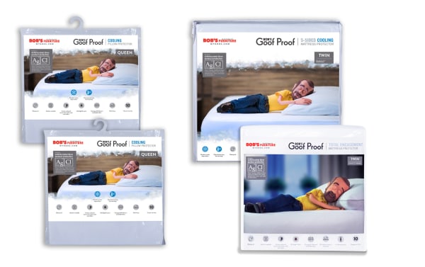 Bob’s Furniture Goof Proof Ultimate Twin Cooling Mattress & Pillow Protector Bundle packaging, featuring antimicrobial nylon and cotton terry fabric, machine washable, moisture-wicking, cooling fiber technology for heat dispersion, liquid stain and allergen protection, shown in white with product images of a man sleeping on bed.