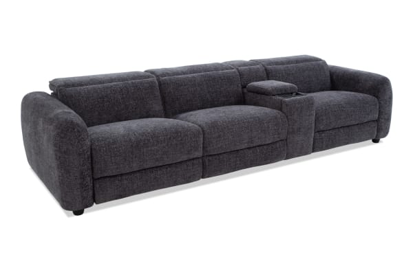 Dark gray fabric sectional sofa with plush cushions, rounded armrests, and a built-in center console with storage, ideal for modern living rooms.
