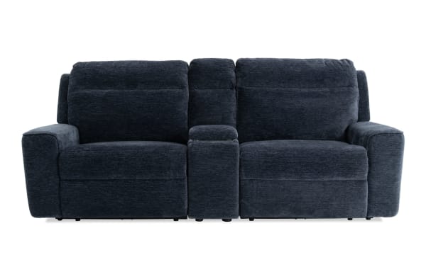 Dark blue fabric reclining loveseat with plush cushions, wide armrests, and a center console for storage and cup holders, ideal for living room comfort.