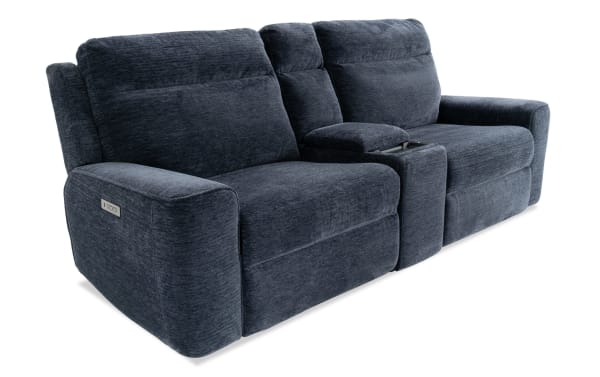 Dark blue fabric reclining loveseat with plush cushions, padded armrests, and a center console with cup holders, ideal for living room comfort.