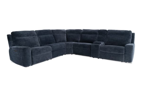 Dark blue sectional reclining sofa with plush fabric upholstery, padded armrests, and built-in cup holders, designed for living room comfort.