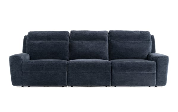 Dark gray fabric three-seat reclining sofa with plush cushions and padded armrests, designed for living room comfort and modern style.