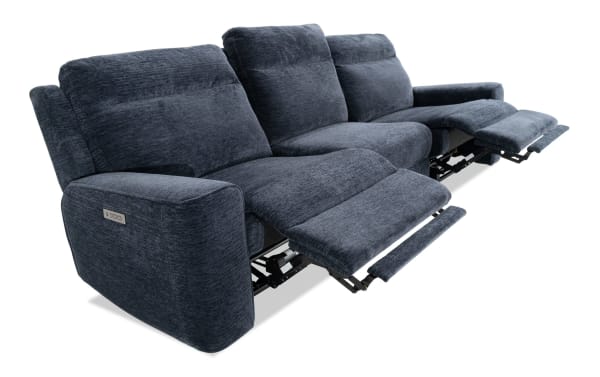 Dark blue fabric reclining sofa with three seats, plush cushioning, and visible metal reclining mechanisms, ideal for living room comfort.