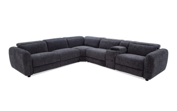 Dark gray fabric sectional sofa with plush cushions, rounded armrests, and a built-in center console with storage, ideal for modern living rooms.