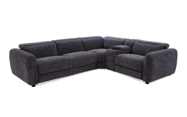 Dark gray fabric sectional sofa with plush cushions, rounded armrests, and a built-in center console with cup holders, ideal for modern living rooms.