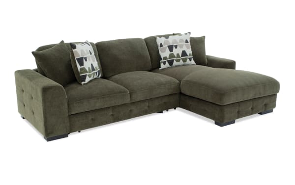 Playground Forest 116" right arm facing pop-up sleeper chaise sectional in green polyester fabric with hand-tufted detailing, oversized pillows, and storage ottoman.