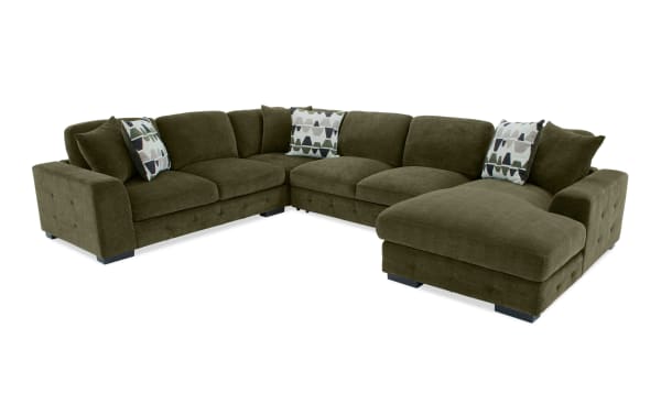 Plush green Playground Forest 145'' 4-piece sectional with right-arm chaise, polyester fabric upholstery, tufted cushions, oversized pillows, and armless pop-up sleeper.