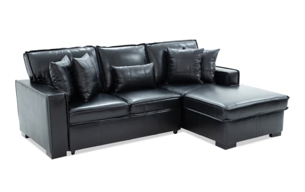 Black leather sectional sofa with chaise lounge, tufted cushions, and multiple matching throw pillows, showcasing modern living room furniture design.
