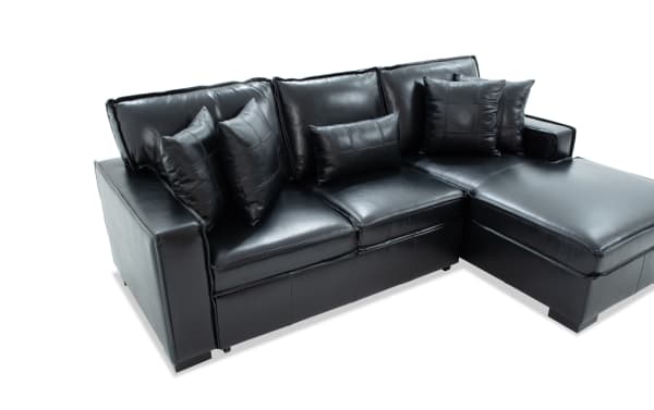 Modern black leather sectional sofa with chaise lounge, featuring plush cushions and sleek, contemporary design for living room comfort.