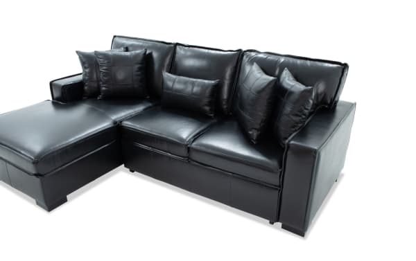 Black leather sectional sofa with chaise lounge, featuring stitched cushions and multiple matching throw pillows, modern design.