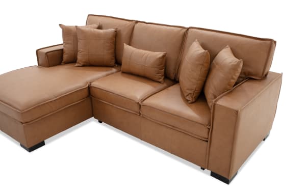 Brown leather sectional sofa with chaise lounge, featuring five matching leather cushions and modern, clean-lined design.