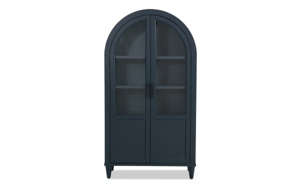 Domus Navy Arch Cabinet in transitional style with navy rubberwood and MDF, featuring arched top, glass doors, and sleek black handles for stylish storage.