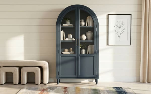 Domus Navy Arch Cabinet in transitional style, made of rubberwood solids and MDF, features a tall navy blue arched silhouette with glass doors for display and storage.