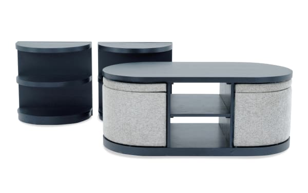 Hampton Black & Gray Oval Storage Coffee Table and 2 End Tables set in contemporary style with gray MDF and polyester fabric, featuring open shelves and hidden storage ottomans.
