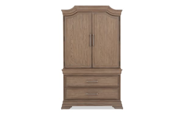 Wooden armoire with a natural oak finish, featuring two paneled doors with metal handles and two spacious lower drawers with matching metal pulls.
