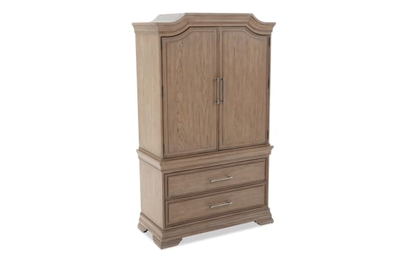Wooden armoire with a natural oak finish, featuring two paneled doors with metal handles on top and two large drawers with metal pulls below.