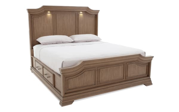 King-size wooden bed frame with built-in storage drawers, raised panel headboard with integrated lights, and matching footboard in a natural oak finish.